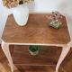 Side table with curved pink legs
