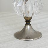 Small vase on a metal stand with thick glass.