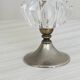 Small vase on a metal stand with thick glass.