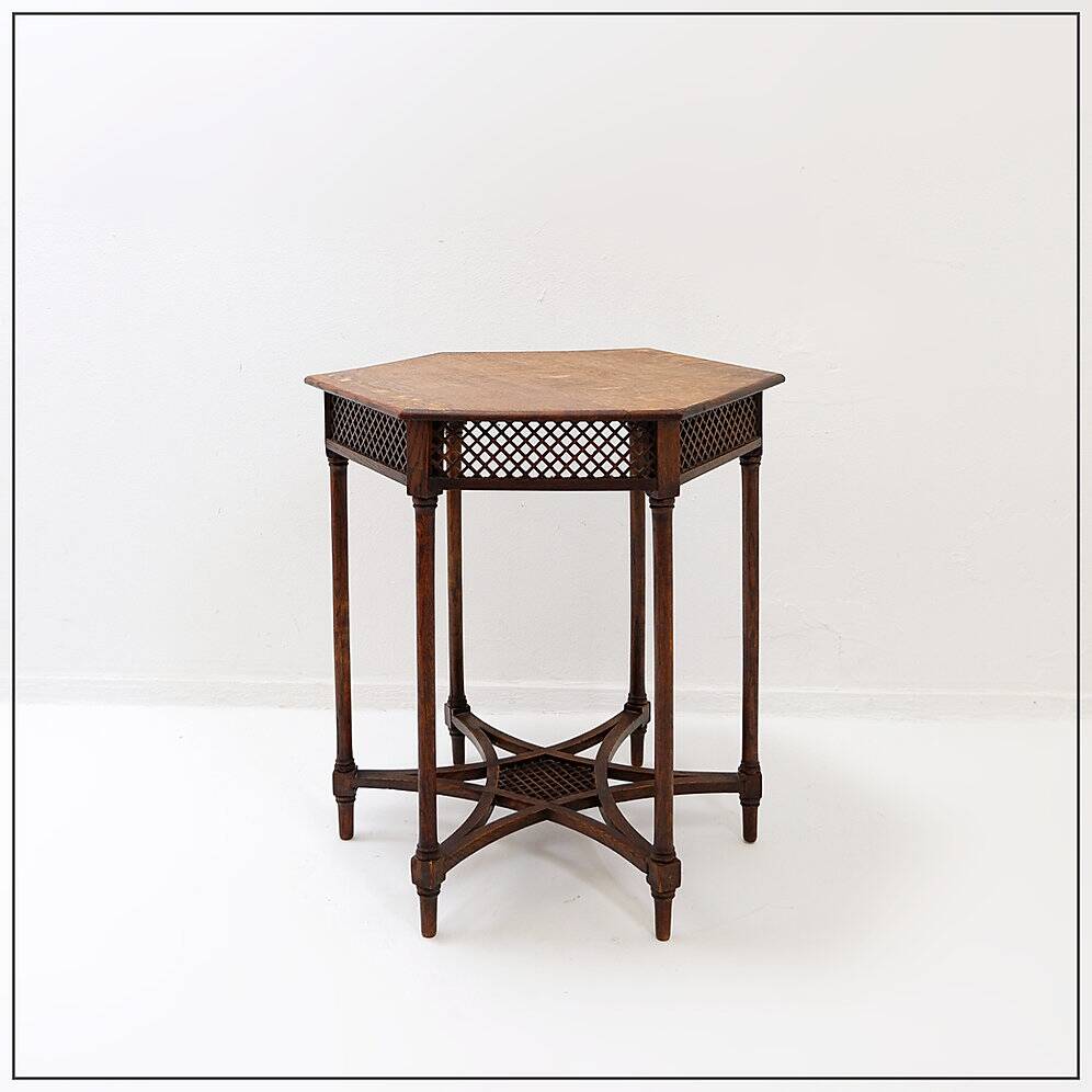 Hexagonal pedestal table or side table with a lattice structure and star pattern.