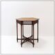 Hexagonal pedestal table or side table with a lattice structure and star pattern.