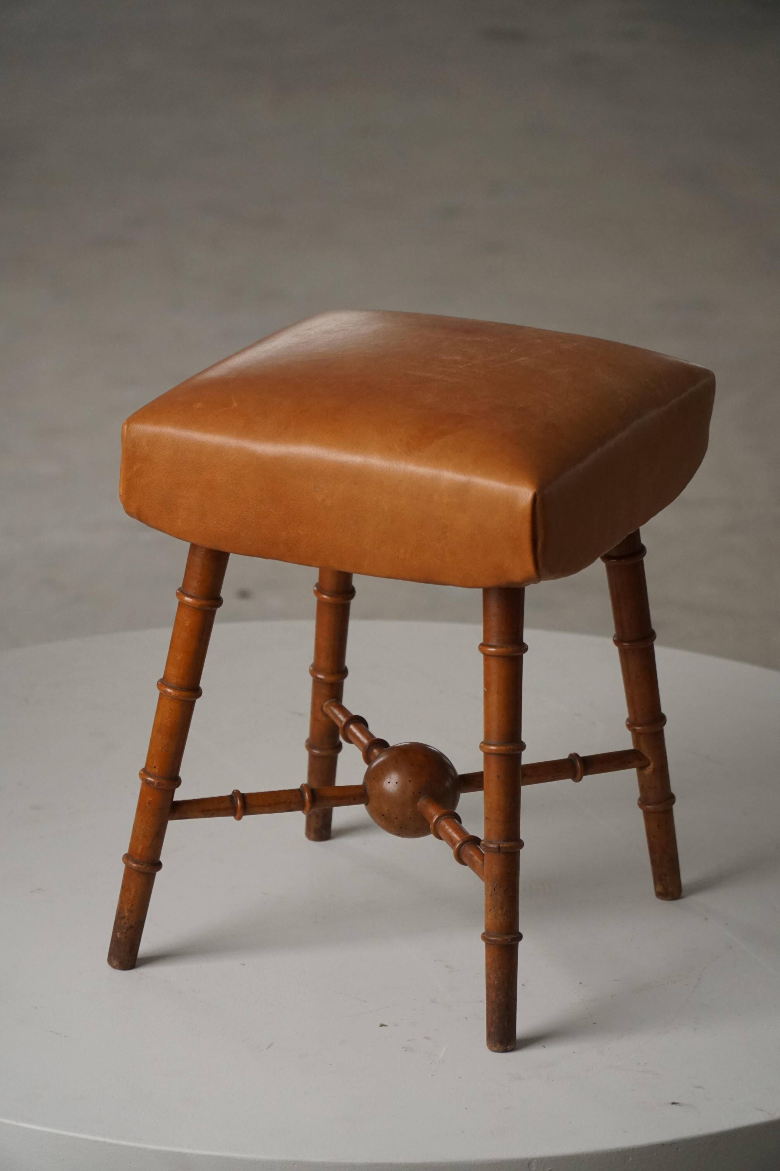 Turned wooden stool with leather seat, mid-20th century, Danish modern.
