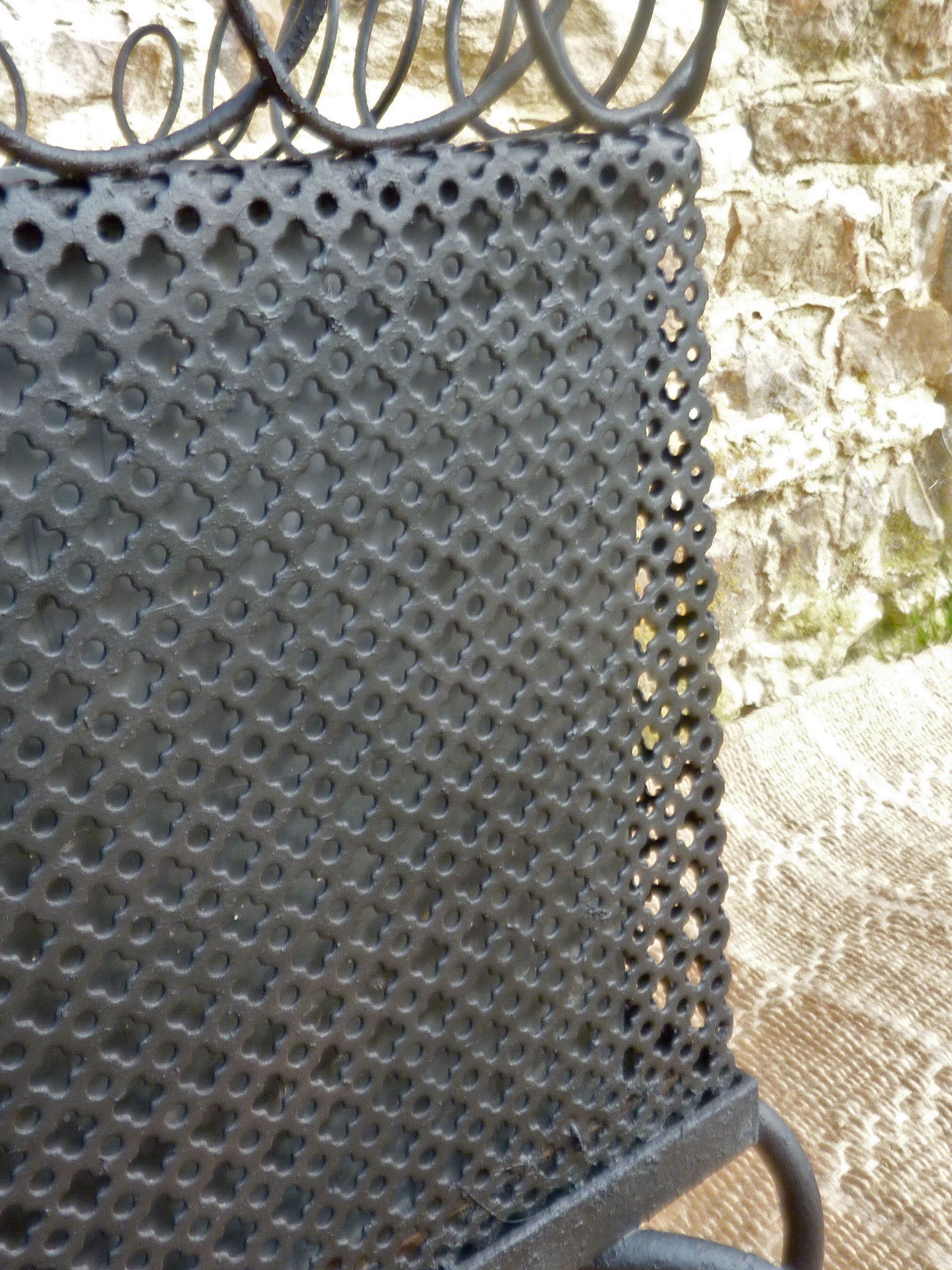 Black perforated metal planter from the 1950s
