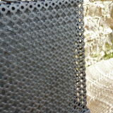 Black perforated metal planter from the 1950s