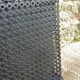 Black perforated metal planter from the 1950s