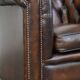 Cowhide English Chesterfield armchair with ball legs and timeless finish