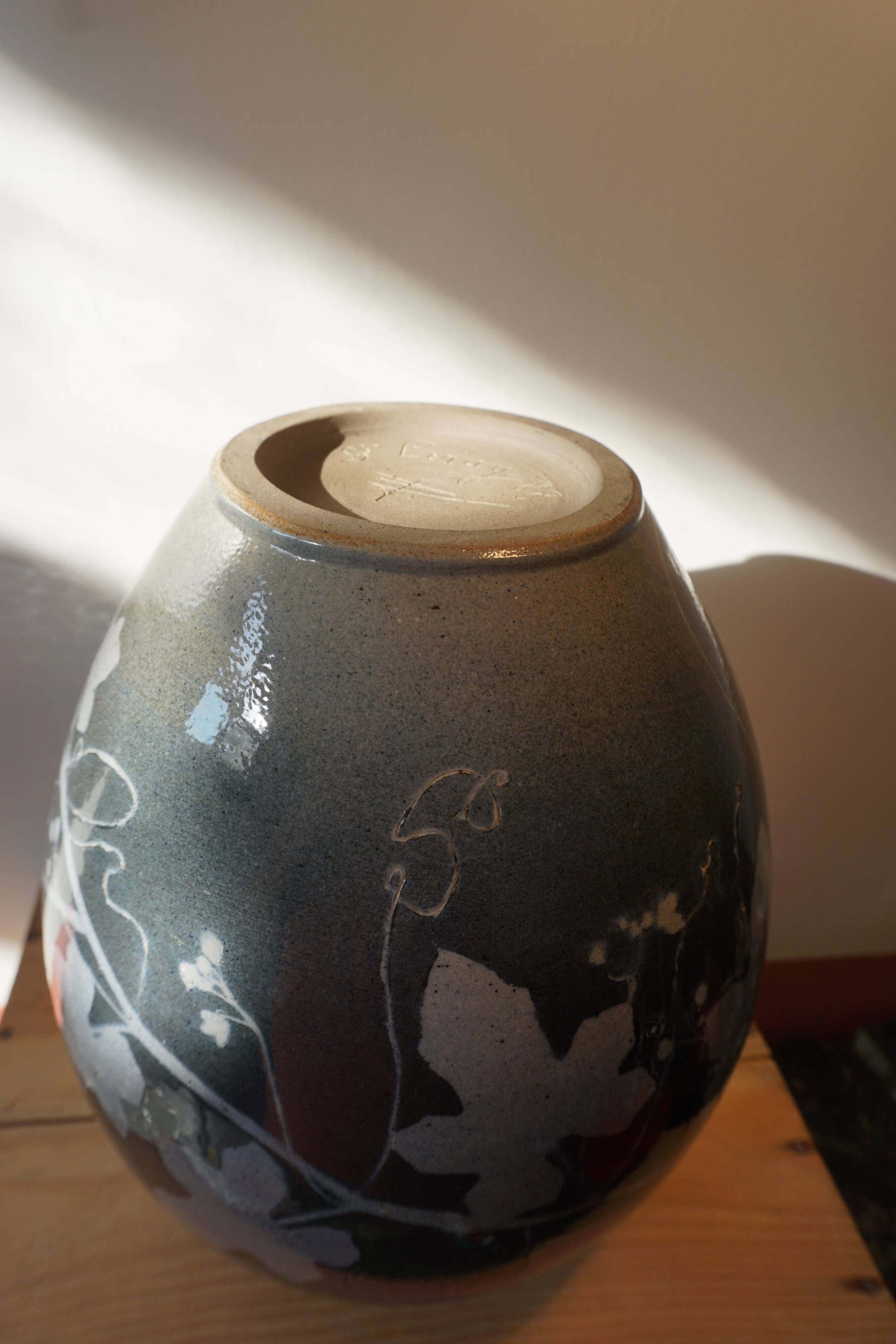 Black vase with plant decoration by Philippe Jacques