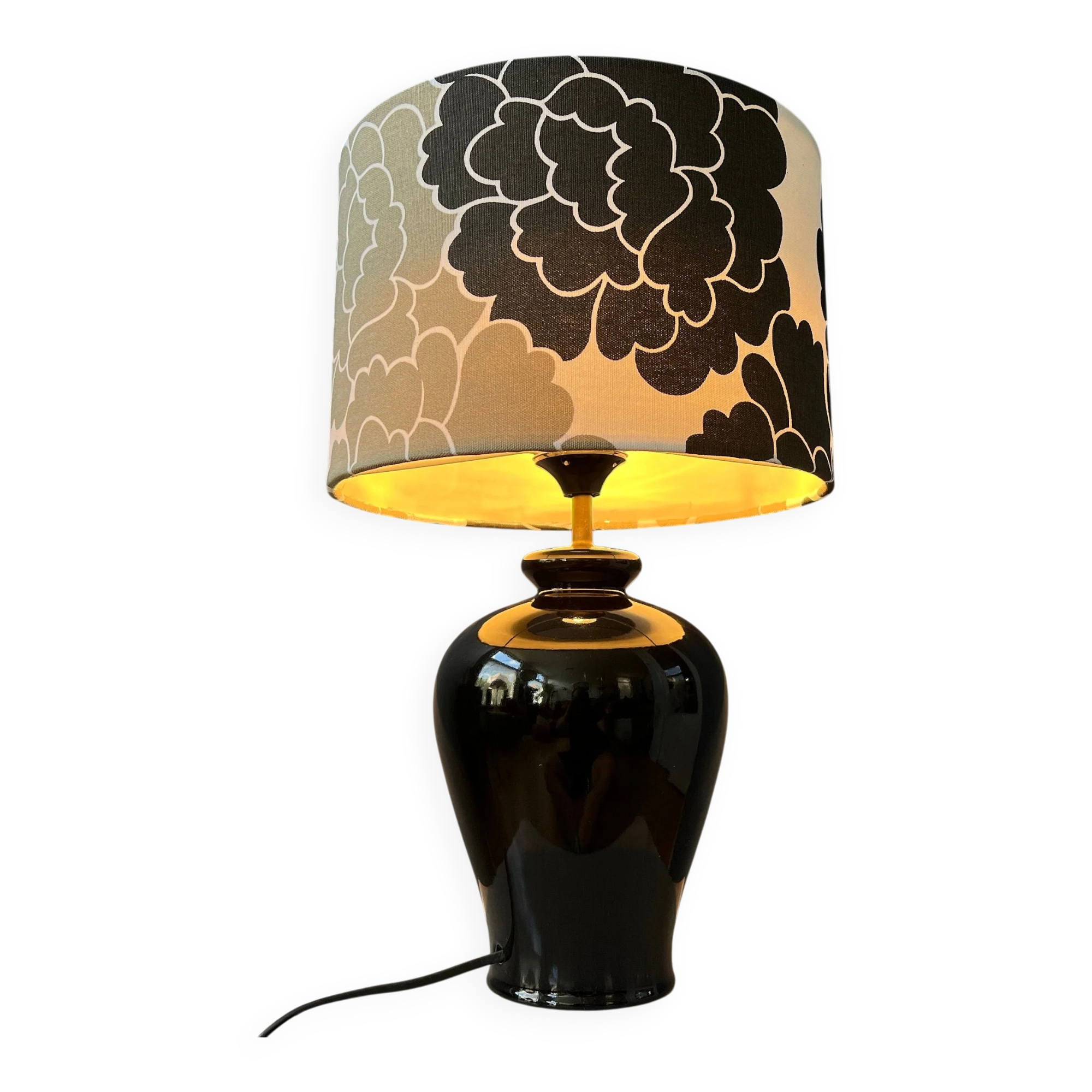 Small Space Age table lamp with a porcelain base and black and white flower shade.