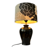 Small Space Age table lamp with a porcelain base and black and white flower shade.