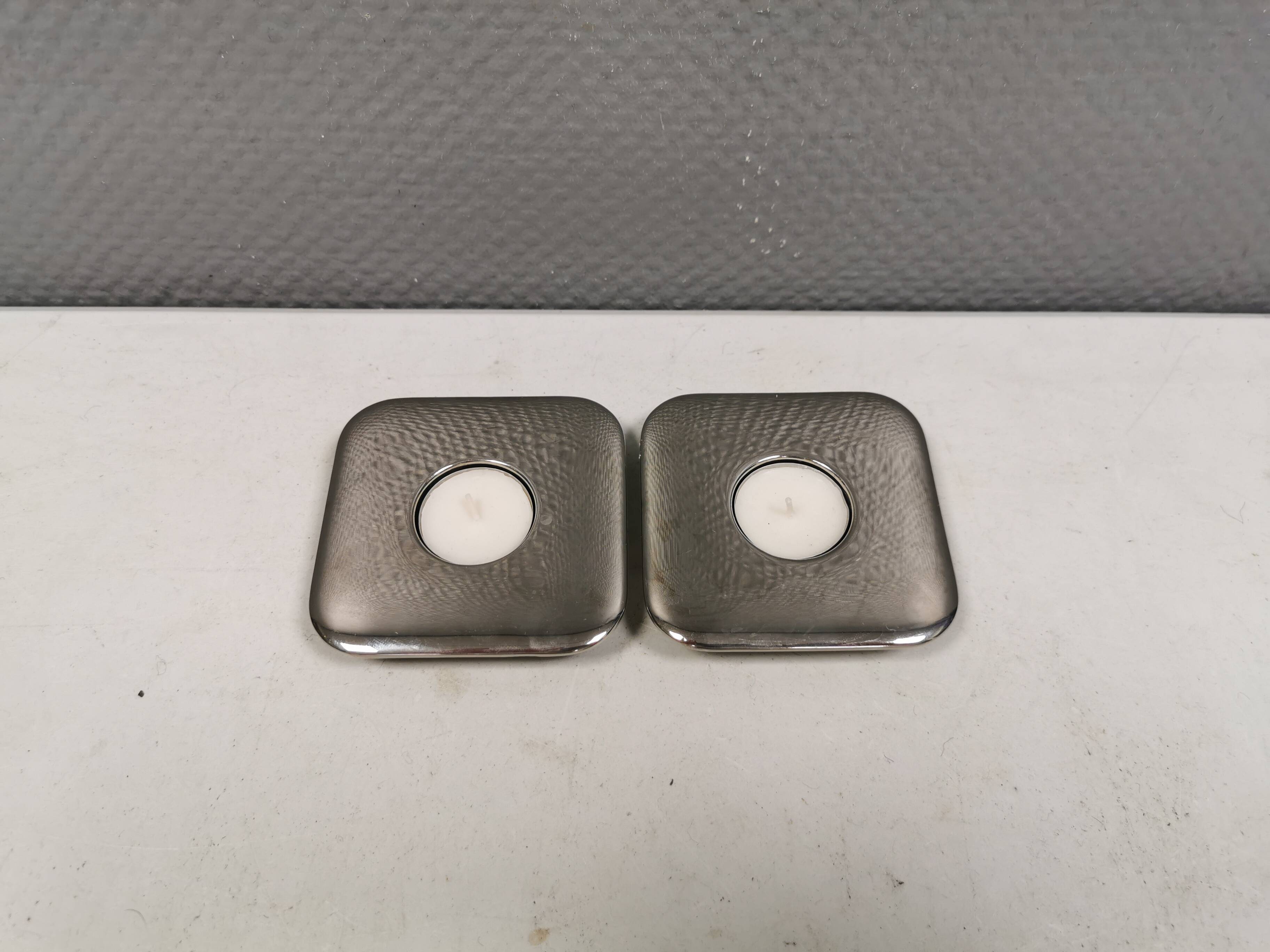 A set of classic Danish candlesticks in polished metal.