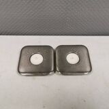 A set of classic Danish candlesticks in polished metal.