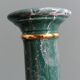 Column candle holder in ceramic with green and gold marble effect.