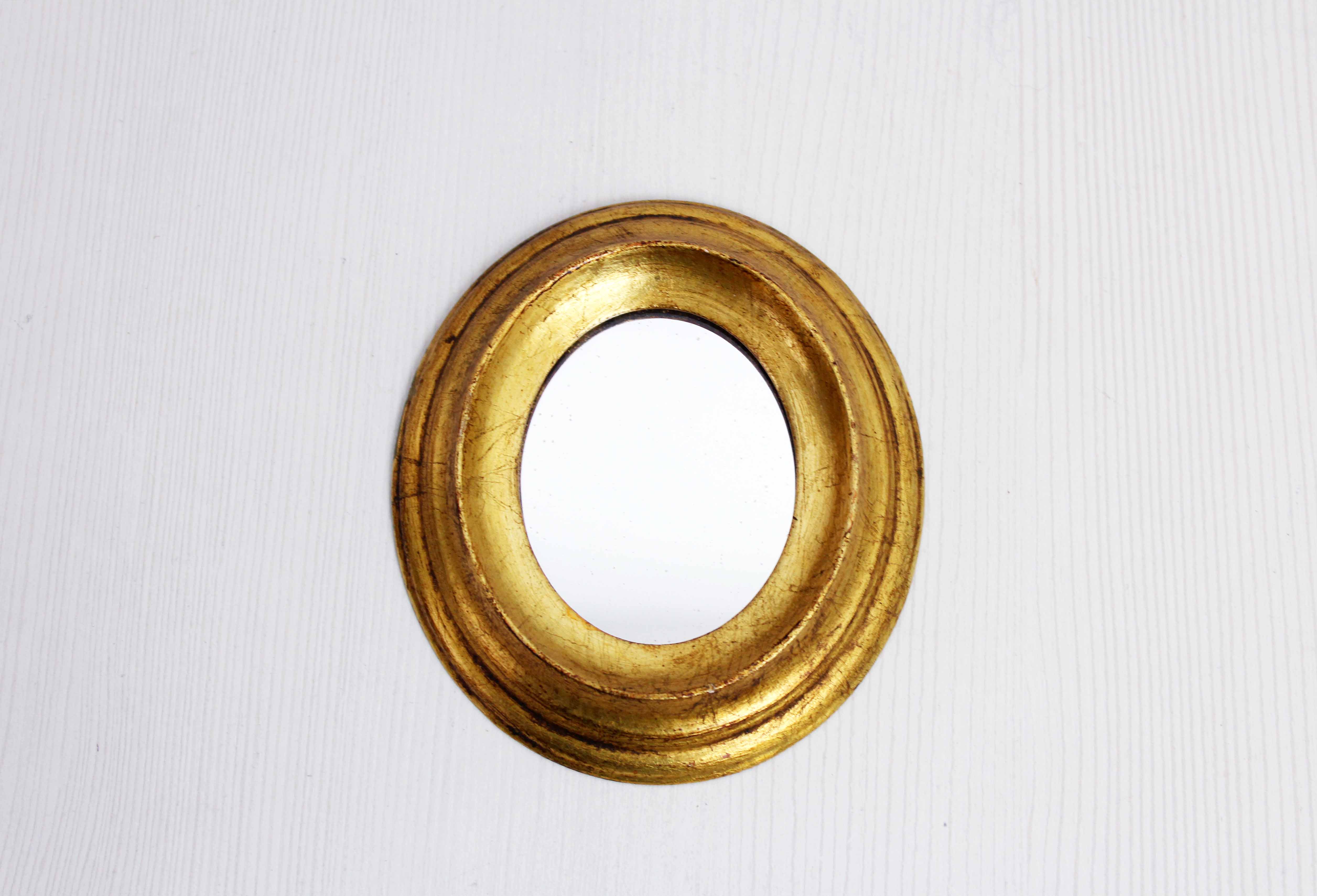 Golden oval mirror