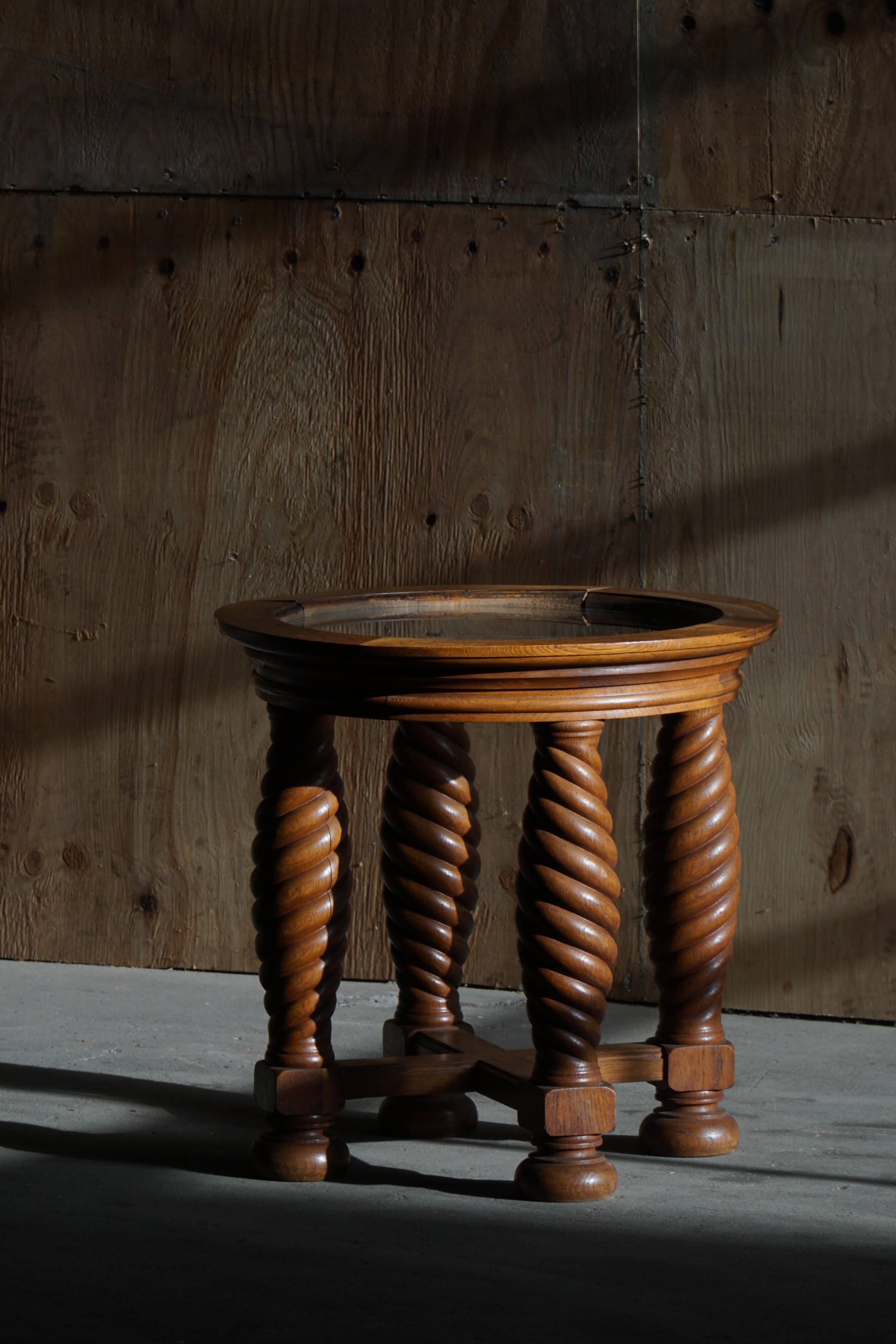 Modern Danish mid-century table, made of oak with spiral turned legs and a glass top, 1950s.