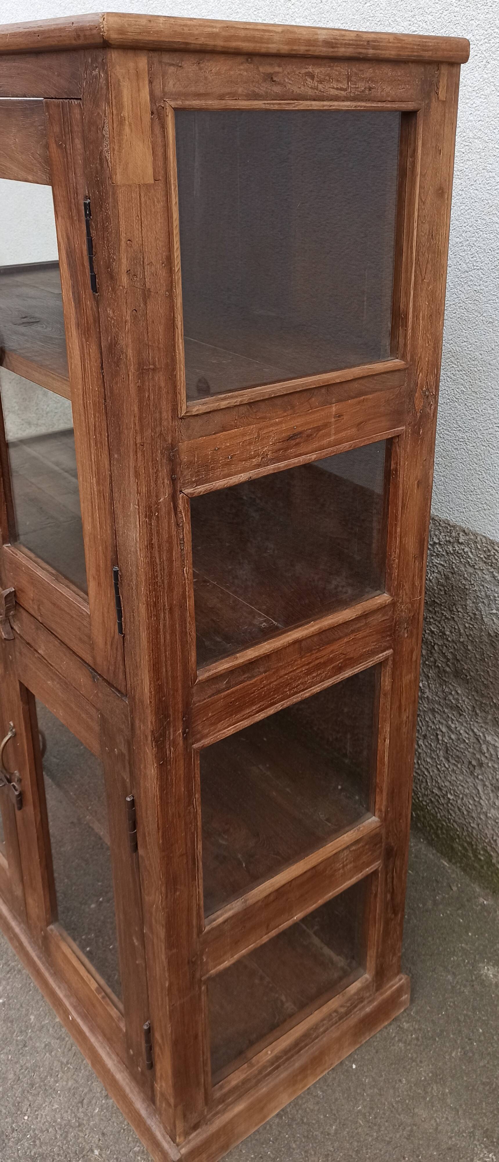 Old wooden display cabinet with three glazed sides