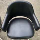 Pair of vintage armchairs in black skai with metal legs.