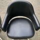 Pair of vintage armchairs in black skai with metal legs.