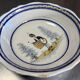 Large earthenware centerpiece dish with painted decoration of a drummer