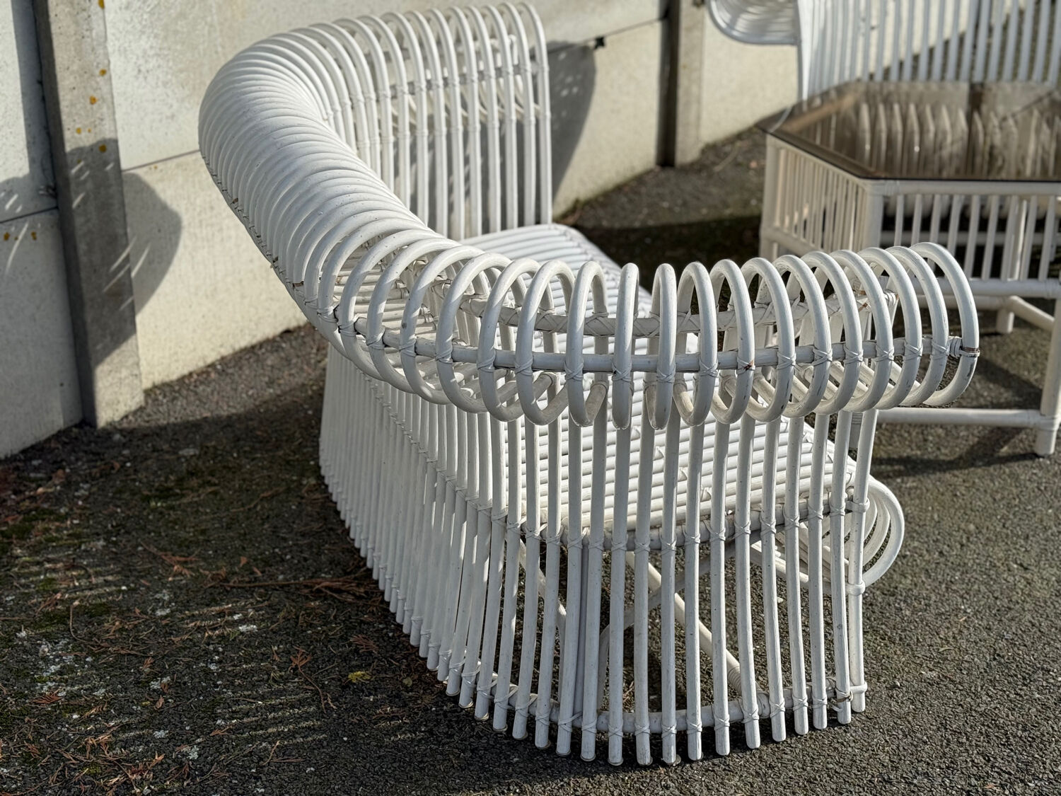 Rattan lounge with two two-seater sofas and a white coffee table.