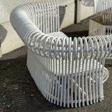 Rattan lounge with two two-seater sofas and a white coffee table.