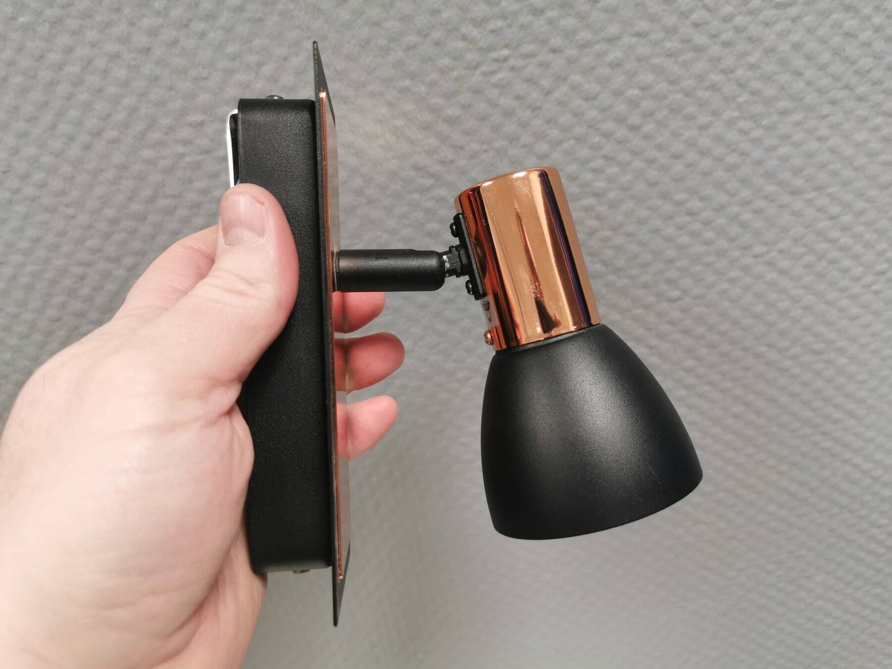 A pair of wall lamps from Eglo, in copper color and black.