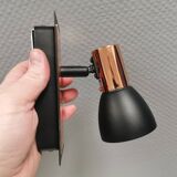 A pair of wall lamps from Eglo, in copper color and black.