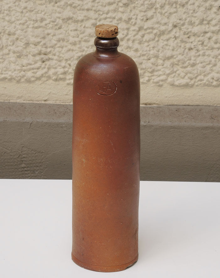 Old enamelled brown sandstone bottle with cork stopper