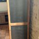 Vintage wooden wardrobe with matte cast iron color hanging rail