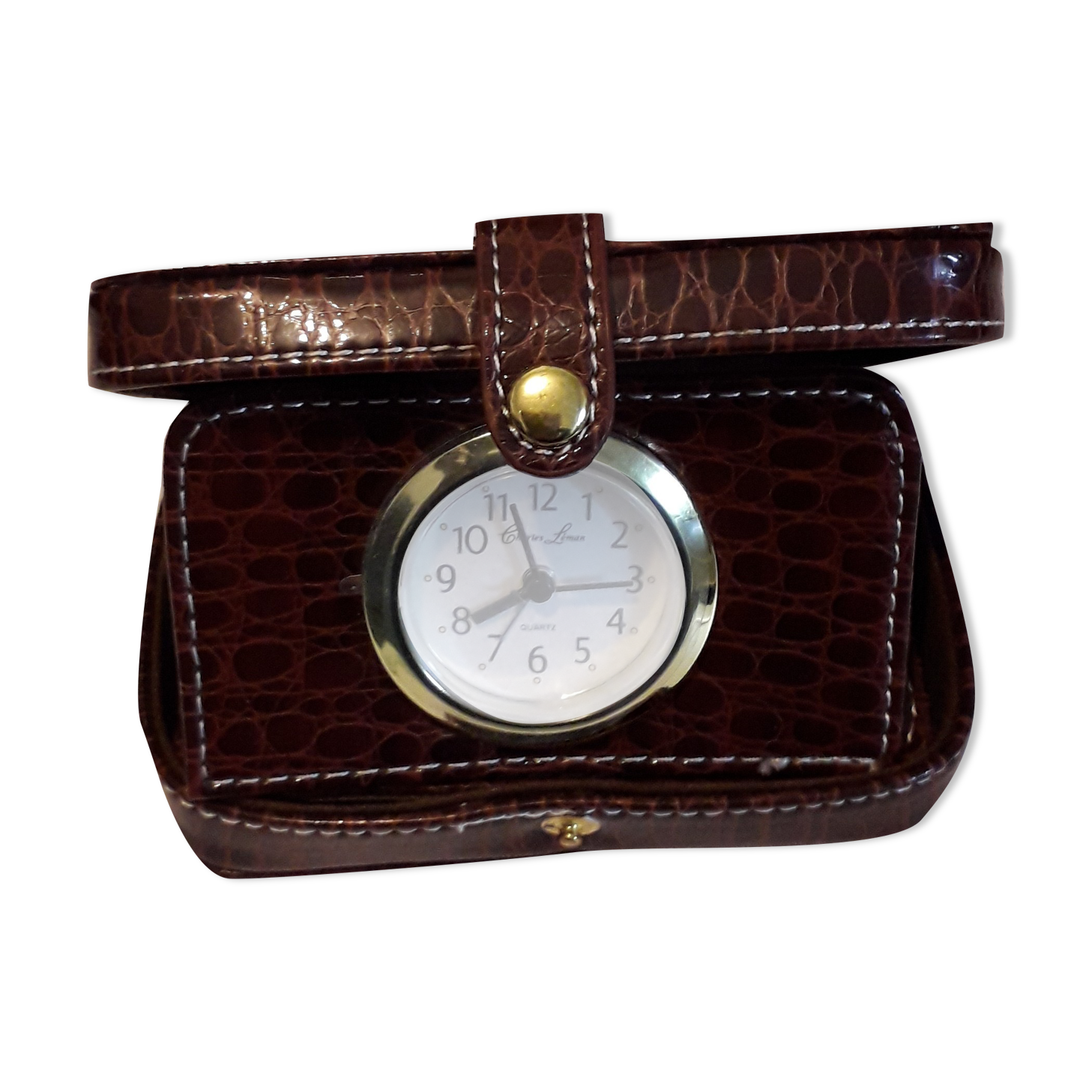 Small travel alarm clock in its case with jewelry compartments