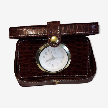 Small travel alarm clock in its case with jewelry compartments