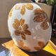 Large vase with golden flowers in ceramic