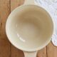 Vintage salad bowl in ivory faience from Chantilly with a rainbow trim.