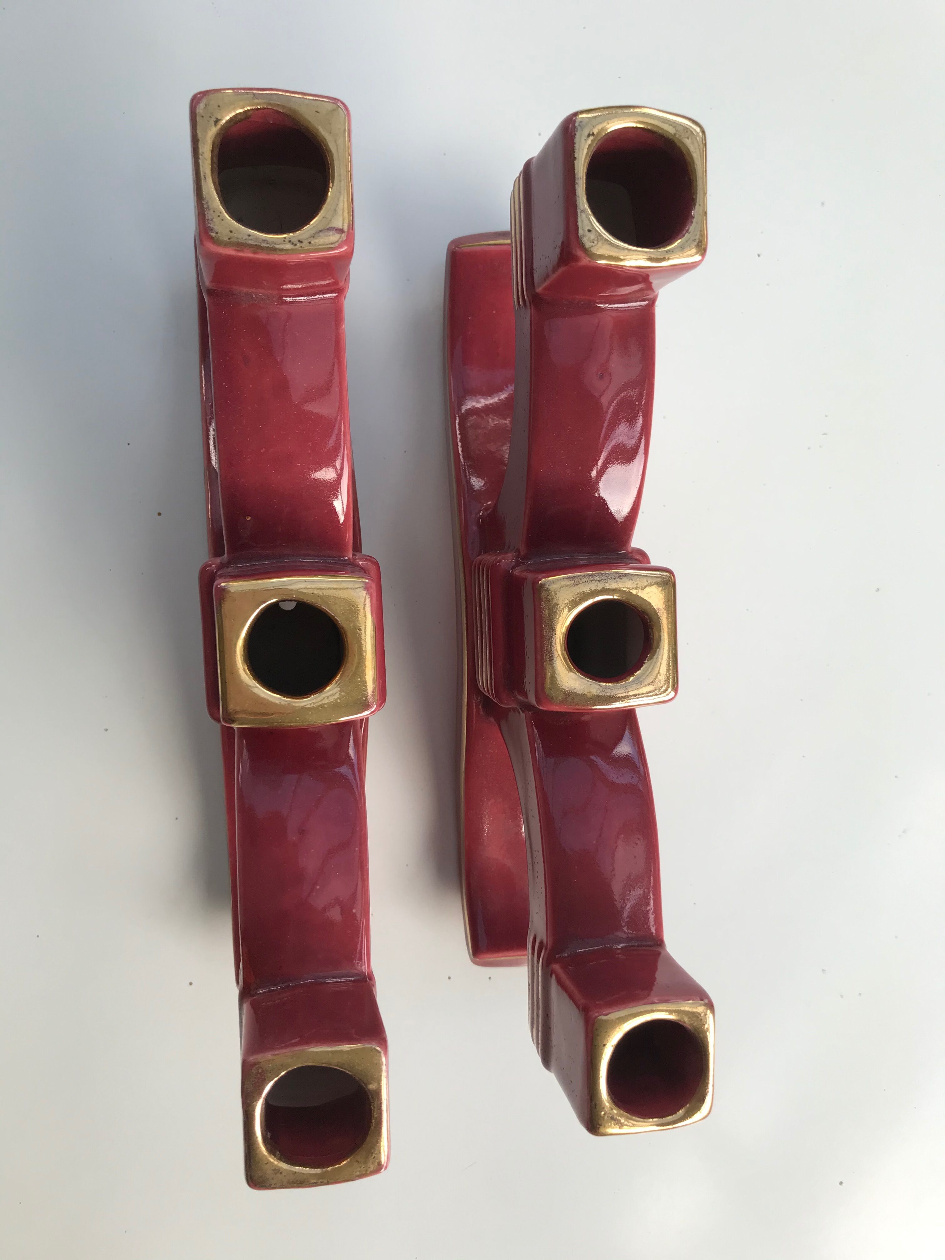 Former pair of burgundy ceramic candlesticks