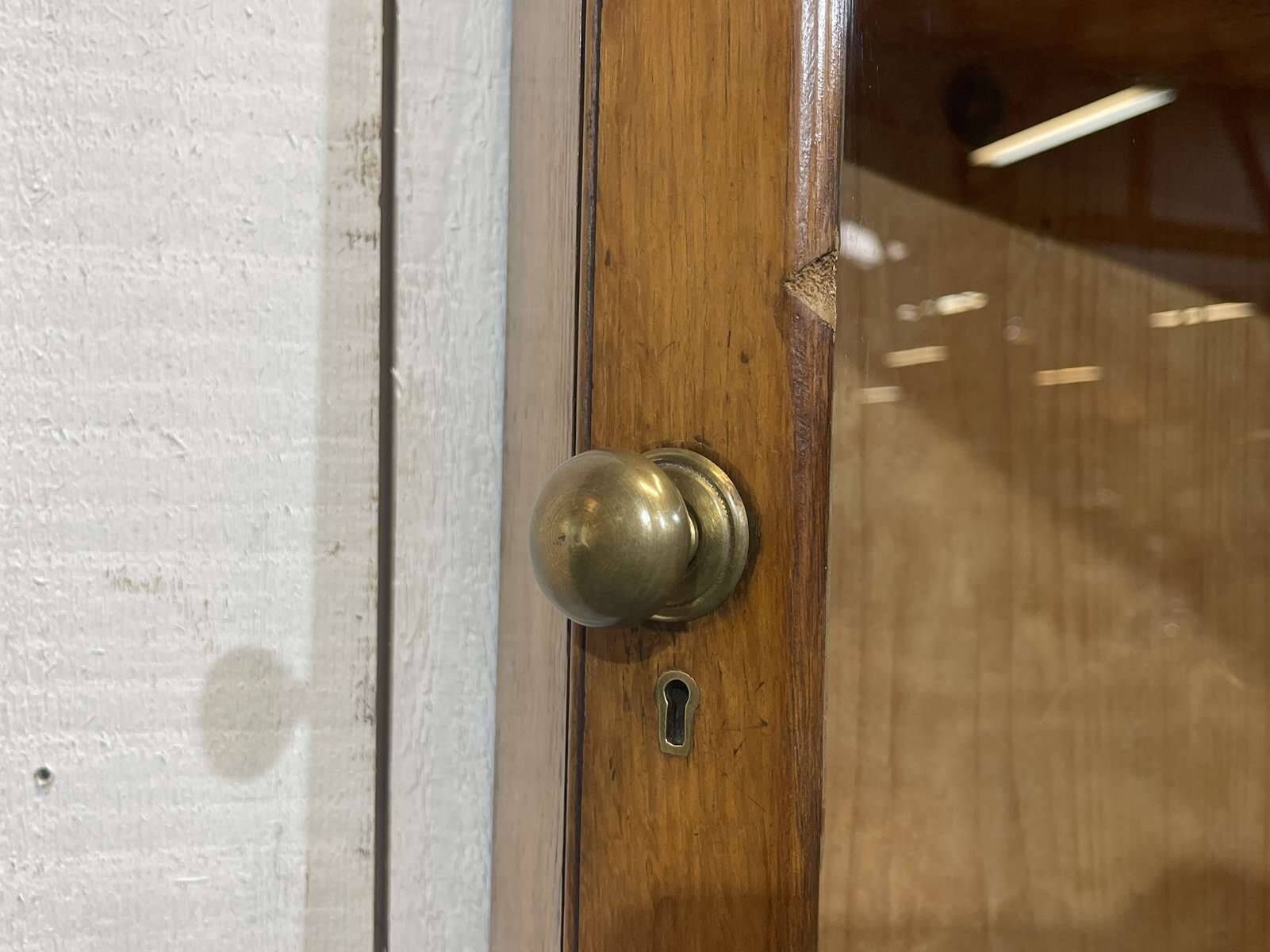 19th-century English corner cabinet in oak, mahogany, and fir.