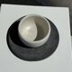 White Indonesian ceramic cup and gray saucer