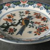 Wall plate in earthenware decorated with painting of flowers and bird 28 cm
