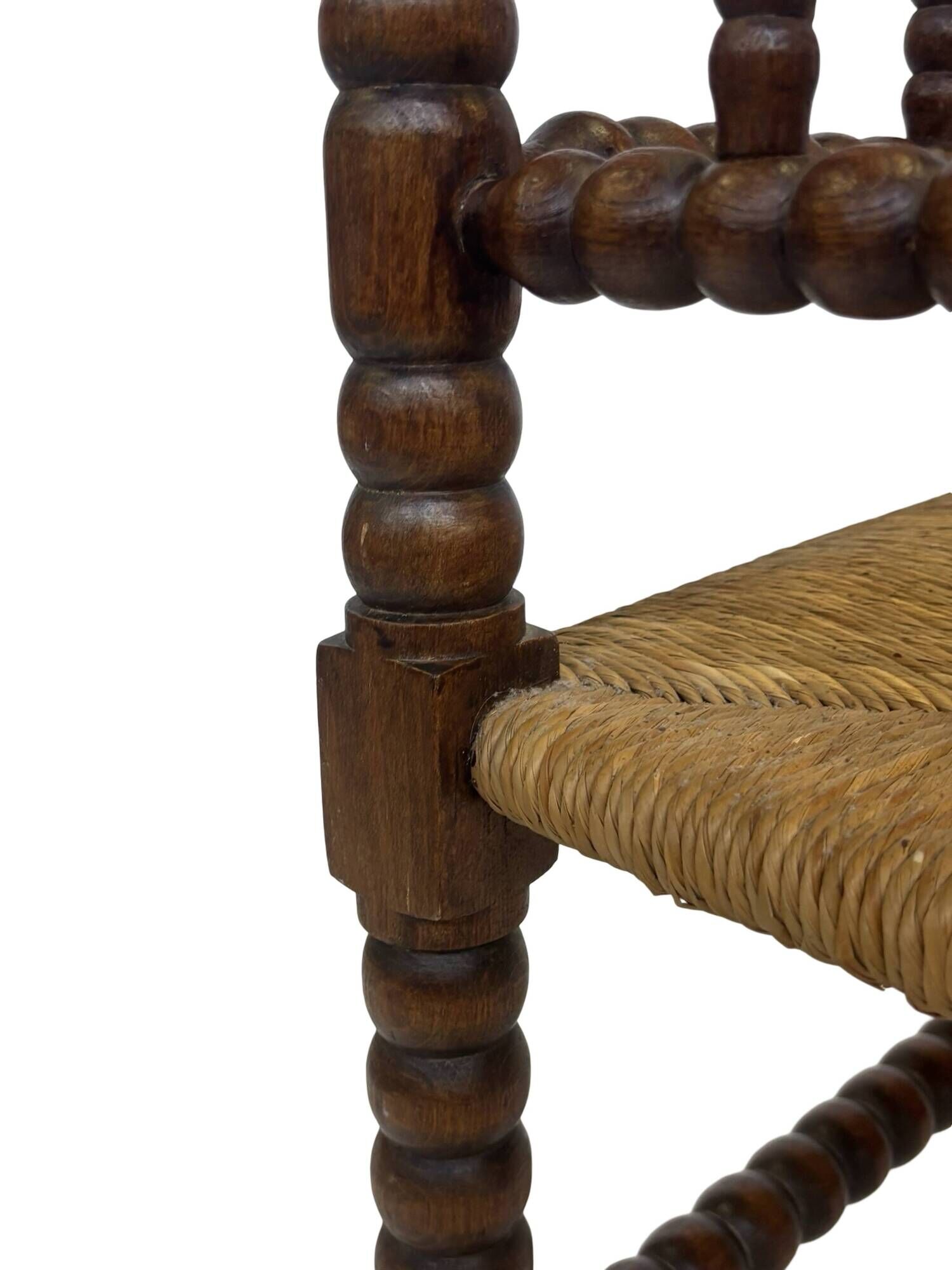 Vintage 'bobbin' bench with a rush seat, 1920s design with armrests.