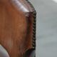 Elegant antique sheepskin leather desk chair with a heavy wooden frame