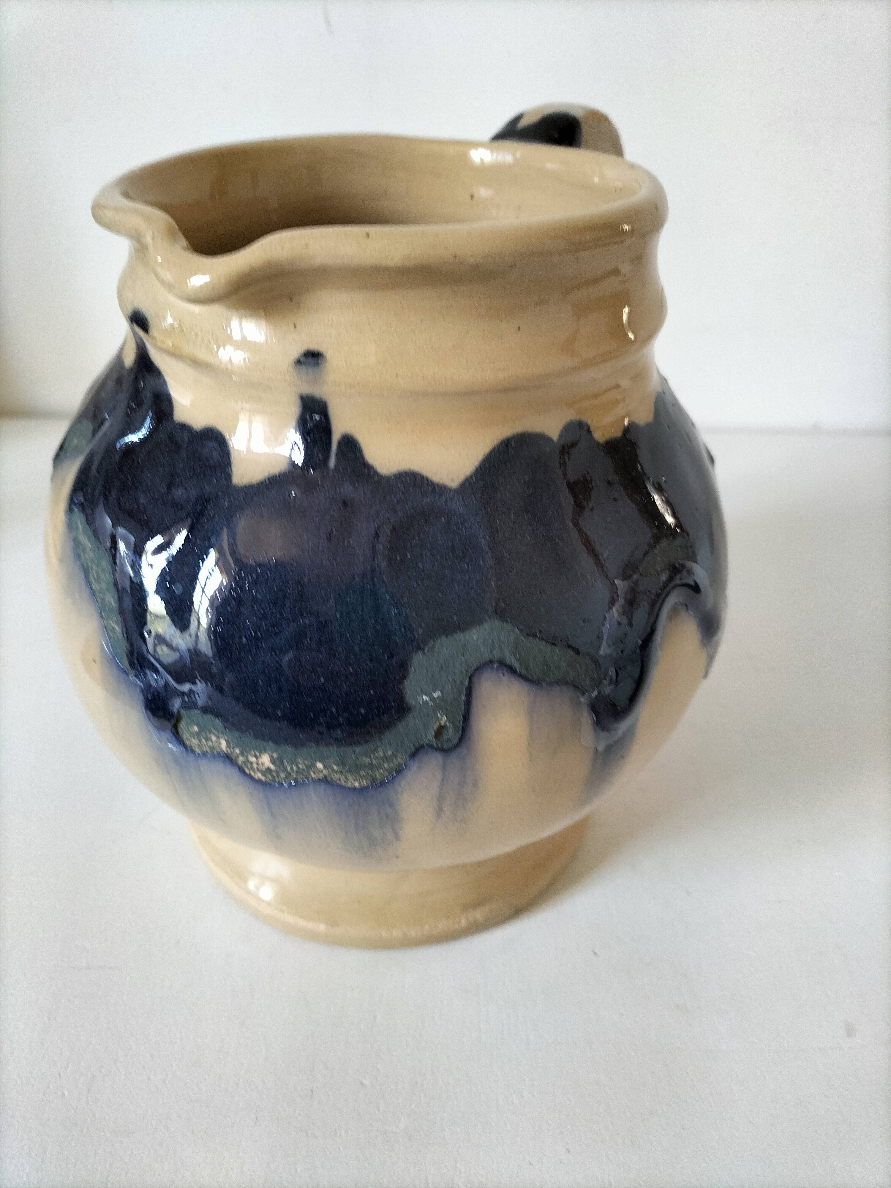 handcrafted ceramic jug with navy blue drip glaze.