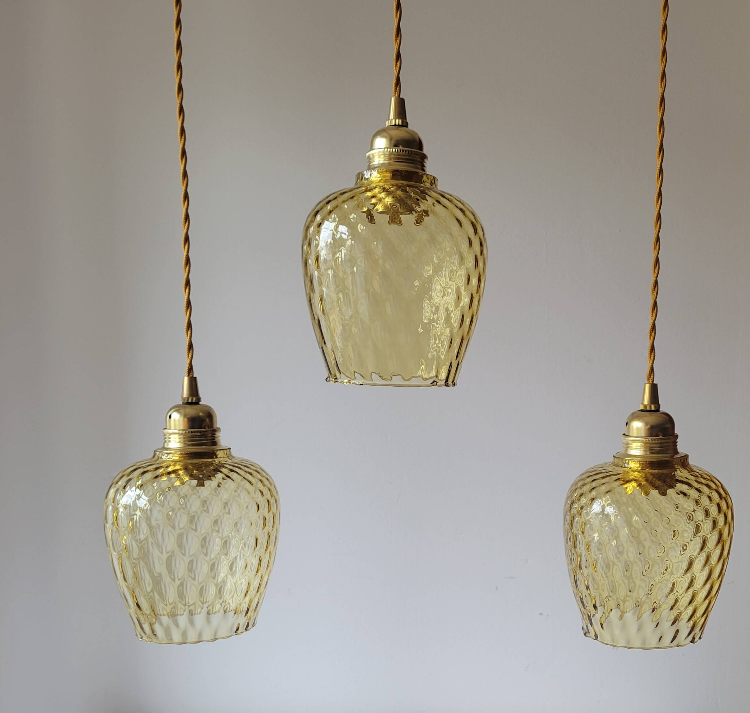 Trio of yellow glass pendant lights