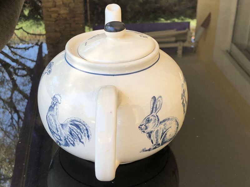 White porcelain teapot decorated with animals