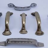 Seven art deco silver tone and brass handles