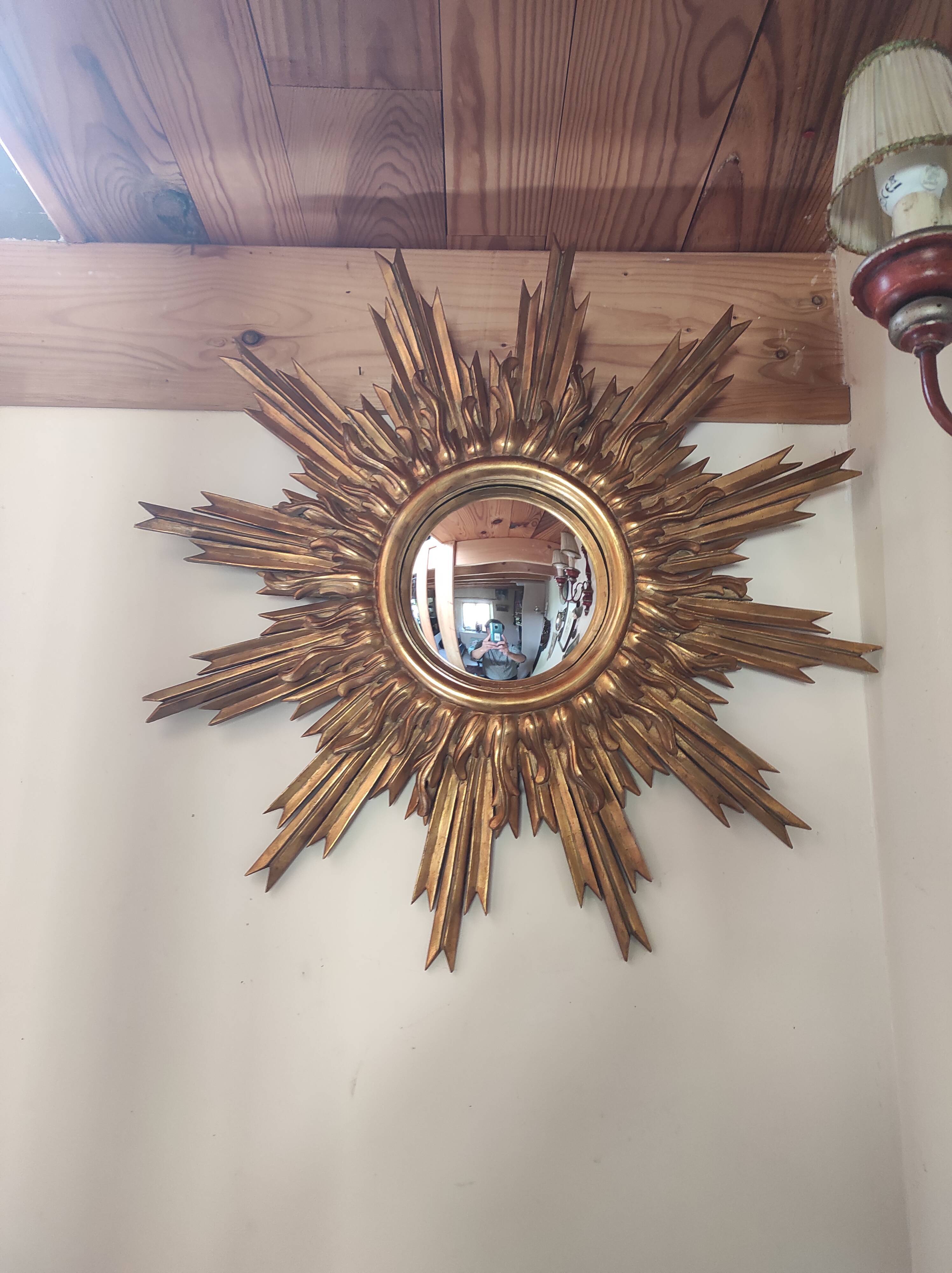 Sun mirror and witch's eye in gilded wood