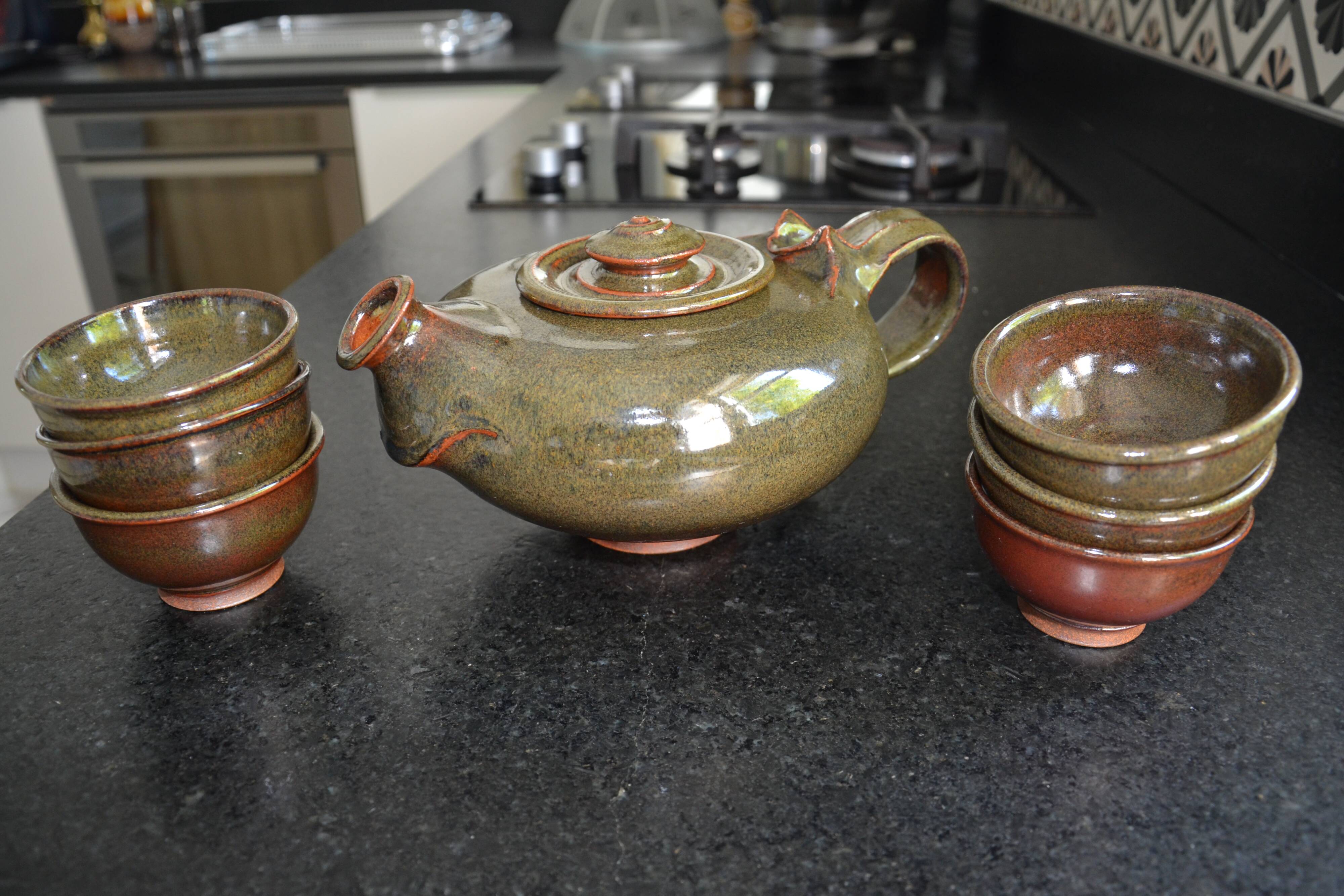 Antique stoneware teapot and its six signed bowls