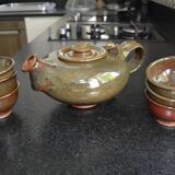 Antique stoneware teapot and its six signed bowls
