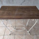 Wrought iron table with a walnut top.