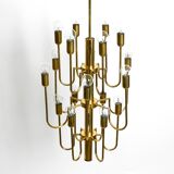 Three staged 18 arm Mid Century brass chandelier with a long brass rod