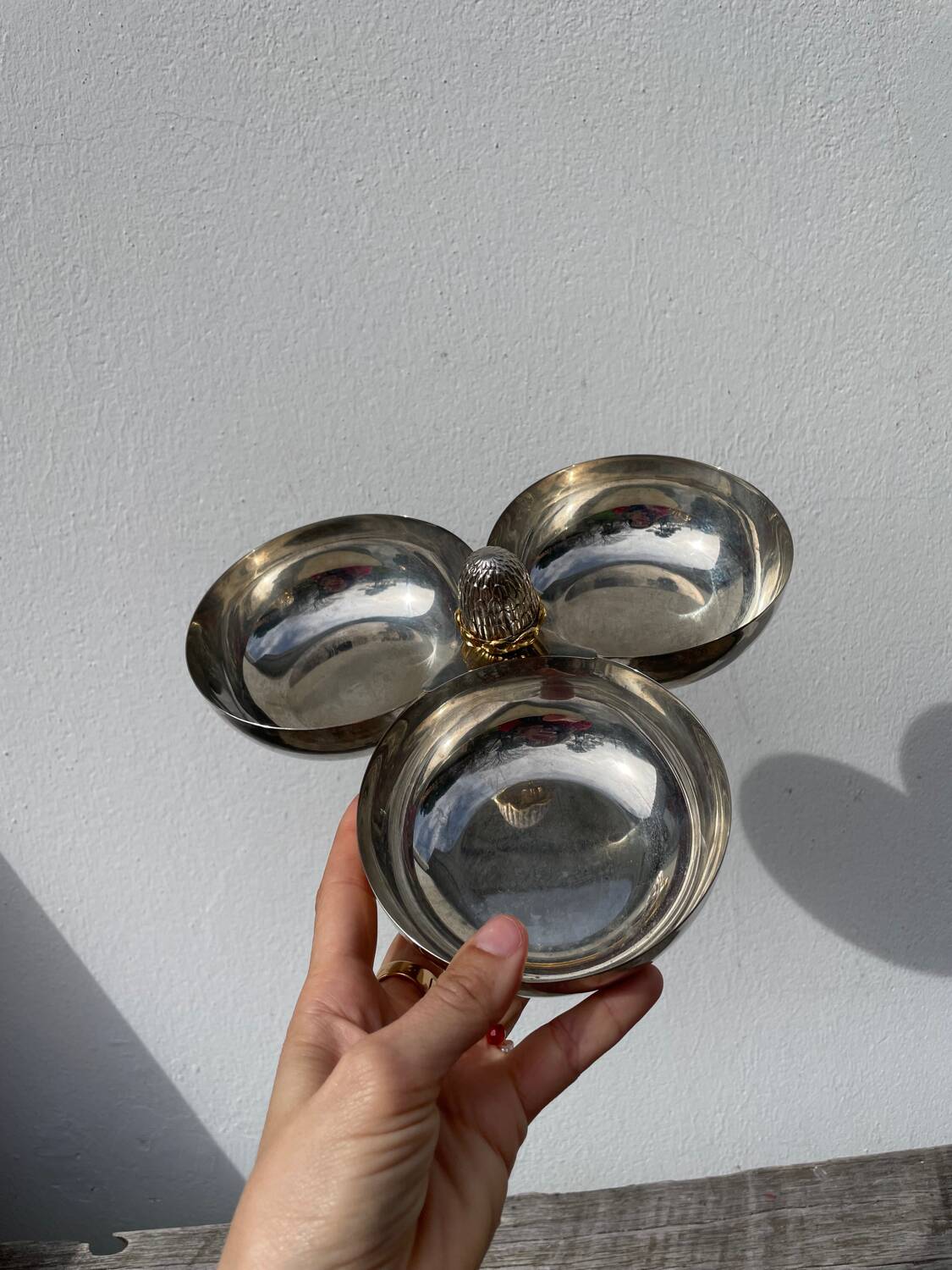 Silver-plated metal dish topped with an acorn