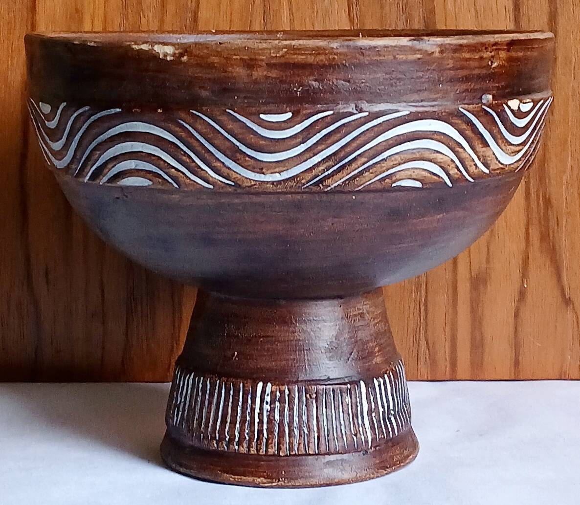 Cup on a pedestal in handcrafted scarified ceramic.