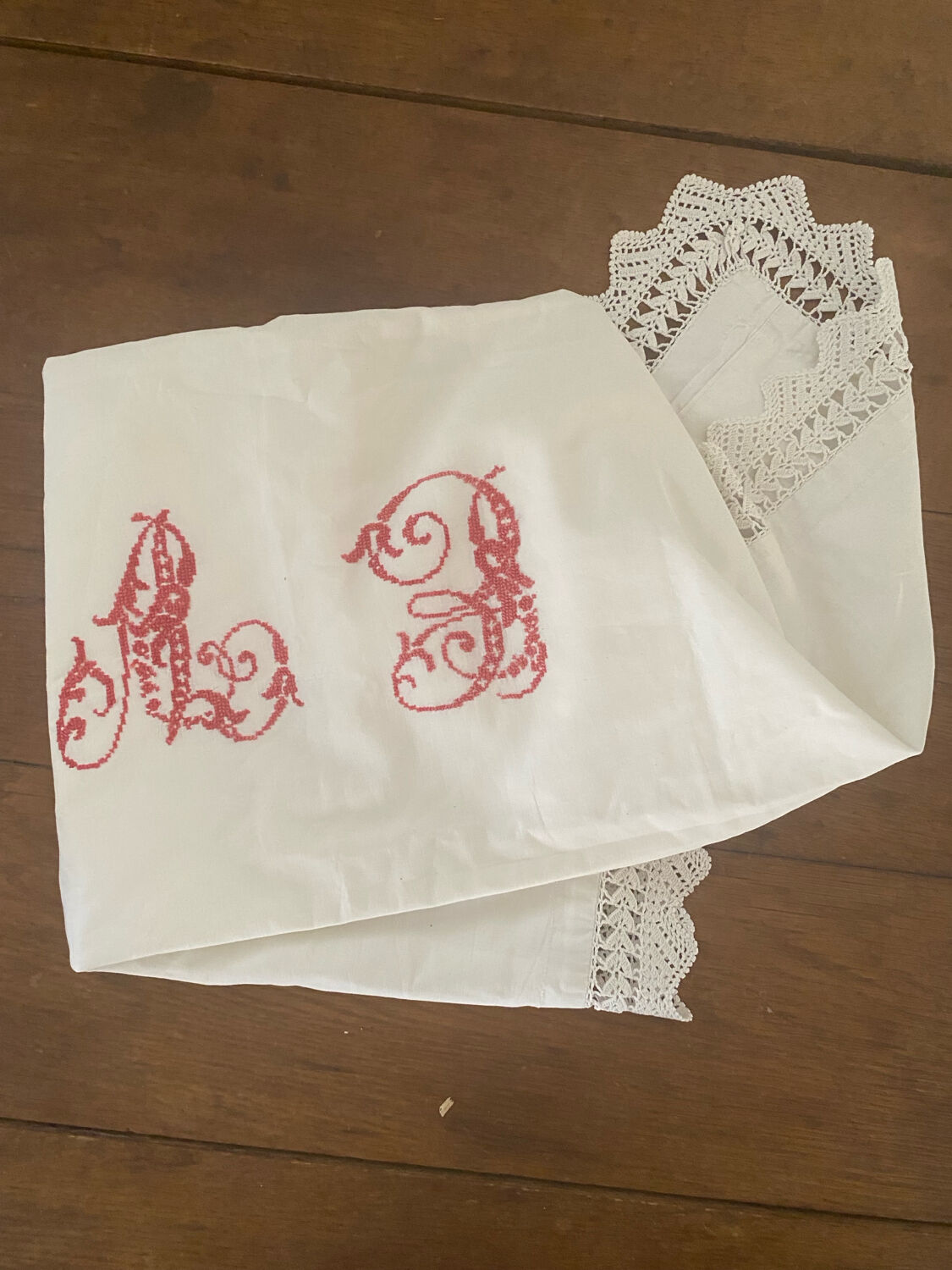 Antique white cotton pillowcase with crochet and monogram.